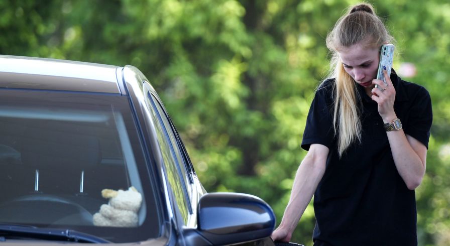 Женщина заправляет автомобиль на автозаправочной станции 