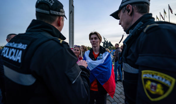 Сотрудники полиции общаются с участниками церемонии возложения цветов у мемориального комплекса "Памятник воинам Советской Армии - освободителям Советской Латвии и Риги от немецко-фашистских захватчиков" в Риге, 10 мая 2022